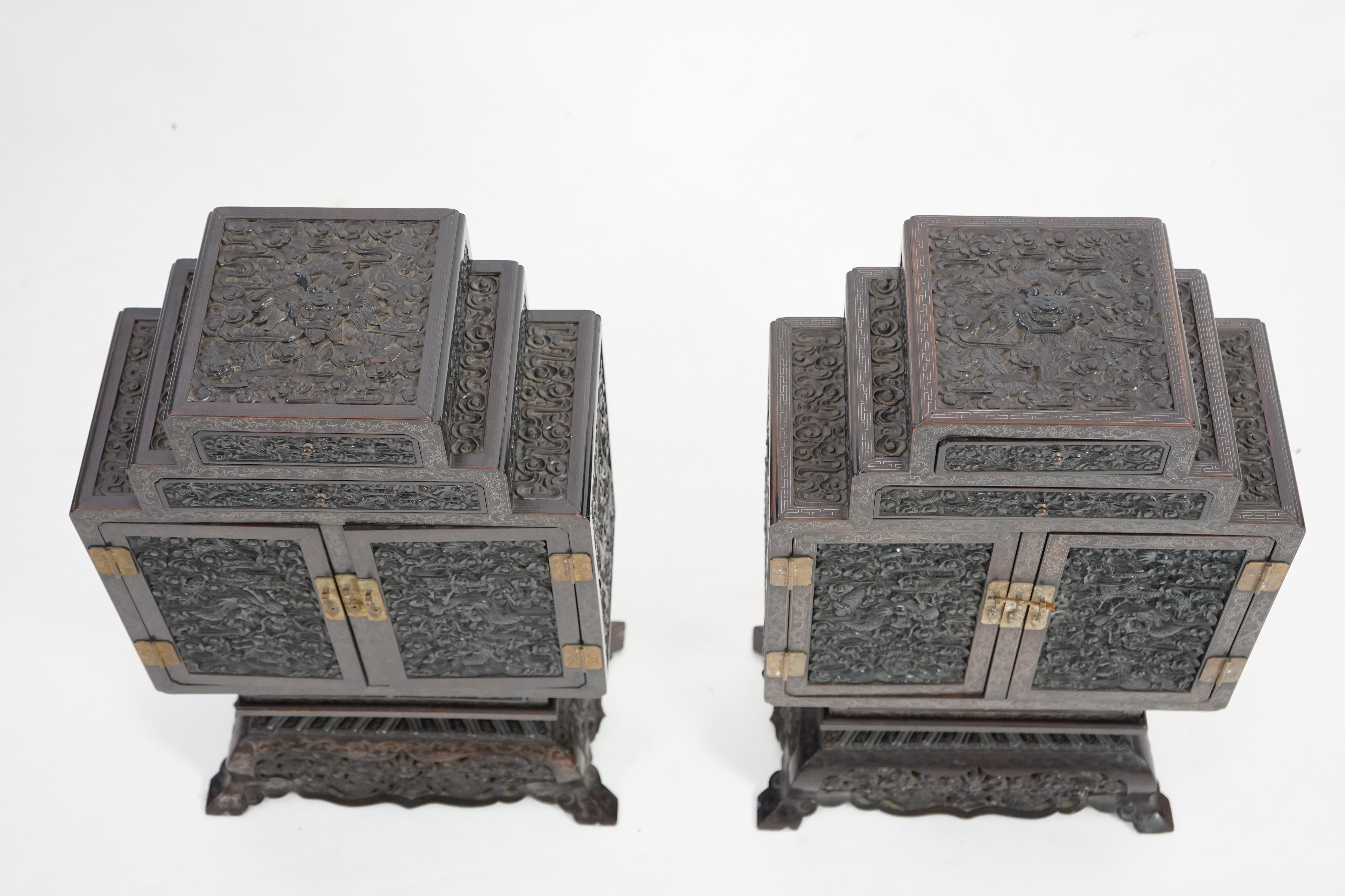 An important pair of Chinese carved zitan and silver wire inlaid ‘cloud and dragon’ curio cabinets and stands, duobaoge, probably Imperial, late Qing dynasty